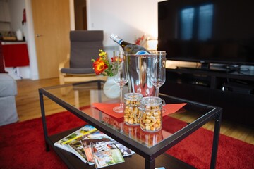 Bottle of chilled champagne on a coffee table in the living room.