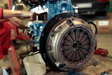 Closeup shot of a young mechanic mounting the car engine