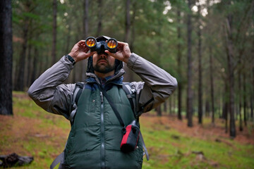 Man, search and adventure in nature for bird watching, walking and wellness in mountains. Trekking,...