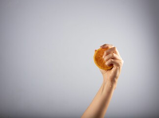 Female fingers in the juicy pulp of an orange