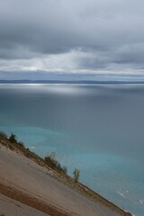 Vertical shot of the sea under the clouded sky