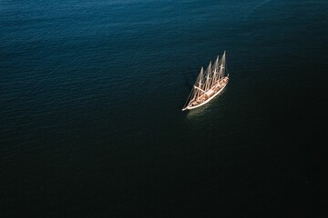Aerial view of a white ship without sails in the blue sea