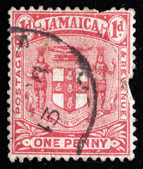 Ukraine, Kiyiv - February 3, 2024.Postage stamps from JAMAICA.An carmine postage stamp showing Arms of Jamaica. Jamaica is an island country situated in the Caribbean Sea. Philately.