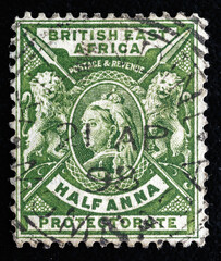 Ukraine, Kiyiv - February 3, 2024.Postage stamps from BRITISH EAST AFRICA. postage stamp depicting portrait of Queen Victoria, British Lions, and native African Javelins (Spears)1896.Philately.