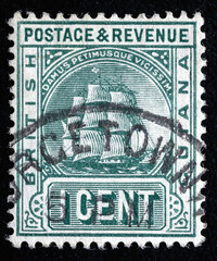 Obraz premium Ukraine, Kiyiv - February 3, 2024.Postage stamps from BRITISH GUIANA.A stamp printed in British Guiana shows frigate and Latin phrase Damus petimusue vicissim, circa 1876.Philately.
