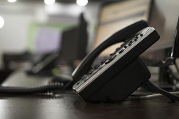 Closeup shot of a landline telephone on office against blur background - obrazy, fototapety, plakaty