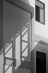 Light and shadow of metal warehouse column on concrete wall surface of industrial office building in black and white style, perspective side view and vertical frame