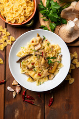 Piatto deliziose farfalle condite con peperoncino e funghi, pasta italiana vegetariana, cibo europeo  - 781233791