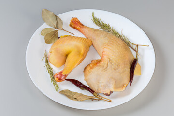 Raw chicken pieces among the different dry spices on dish