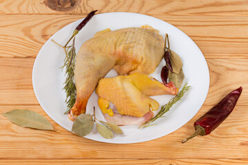 Raw chicken pieces among the different dry spices on dish © An-T