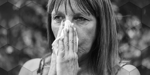 Mature woman blowing her nose, geometric pattern