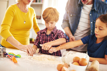 Mother, father and children in kitchen baking cookies for learning, development and bonding as family. Mom, dad and kids mixing ingredients for desserts, pastries or biscuits and cake together