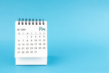 May 2024 mini desk calendar on blue color background.