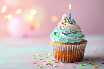 Delicious birthday cupcake on table on bokeh light background