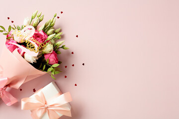 Bouquet of flowers with gift box on pink background. Happy Mothers Day concept. Flat lay, top view.