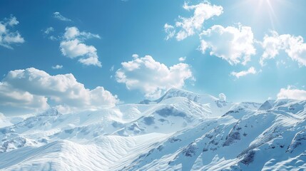 A breathtaking snowy mountain ridge basks in the brilliant sunlight, with the blue sky above punctuated by soft, white clouds. - obrazy, fototapety, plakaty