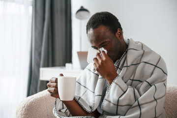 Terrible flu. Sick black man is at home
