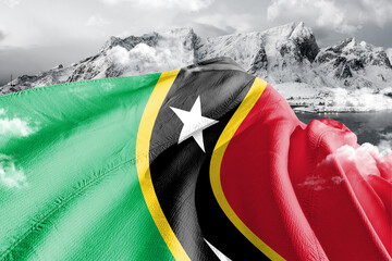 Saint Kitts and Nevis national flag cloth fabric waving on beautiful ice Mountain Background.