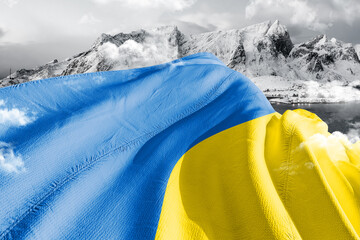 Ukraine national flag cloth fabric waving on beautiful ice Mountain Background.