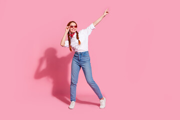 Full length photo of good mood positive lady dressed cowboy outfit dark red glasses dancing isolated pink color background