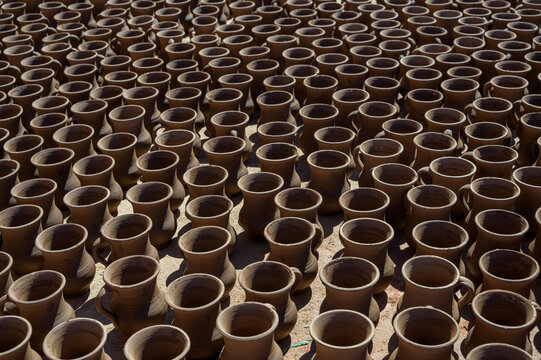 Array of traditional clay pottery in sunlight