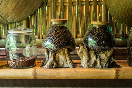 Artisanal coffee beans in glass jars on wooden display