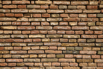 Wall background of bricks with different shades and worn by the passage of time. Concept background, wallpaper, copy space, construction.