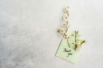 Cherry blossom branches over a thank you card