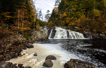 River waterfall in autumn forest. Autumn river waterfall