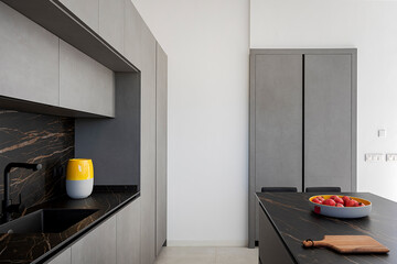 Modern kitchen interior with marble accents and color pop