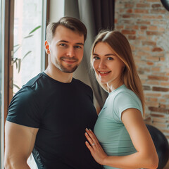 Fototapeta premium Young athletic couple smiling at the camera