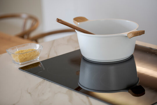 Modern kitchen with induction hob and cooking utensils