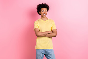Photo of cute charming guy dressed yellow t-shirt smiling arms crossed isolated pink color...