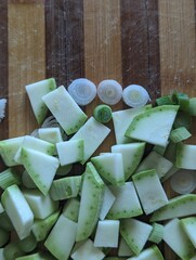 Sliced zucchini and Spring Onion on a wooden board. Fresh vegetables 
