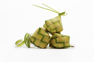 Multiple ketupat pouches (woven palm leaves), a traditional Indonesian dish, on white background