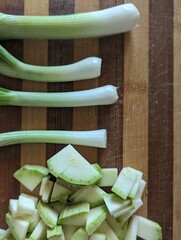 sliced zucchini and green onion on a chopping board