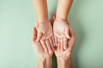 Top view of parents and kid holding empty hands isolated on a color background. Celebrating Family...