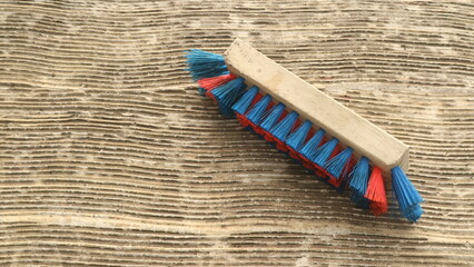 Brush with red and blue bristle for cleaning the floor
