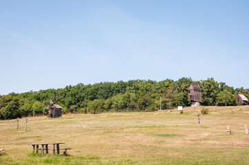 Landscape with traditional Ukrainian windmills houses in countryside village. Windmill mill at rural outdoor. Wind mill. Windmill in a rural area. Wind Farm. Dutch windmill. Wind-driven motion