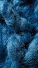 A close-up view showcases a background of blue felting wool, capturing its texture and richness in detail, ideal for creative projects or design inspiration. - obrazy, fototapety, plakaty