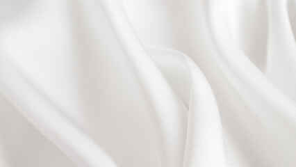 Fototapeta premium A macro photography shot of a white linen cloth with waves, displaying tints and shades. The pattern resembles automotive design elements, with a touch of peach and transparent materials