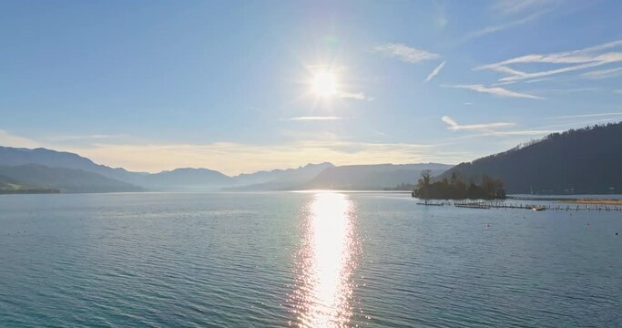 Aerial view landscape of Lake Traunsee in the Austrian Alps. Beautiful sunny nature of the lake at the foot of the mountain ranges. High quality 4k footage