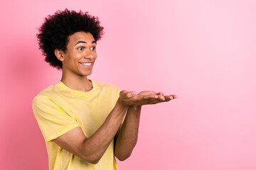 Profile portrait of excited positive man arms palms hold give empty space isolated on pink color background - obrazy, fototapety, plakaty