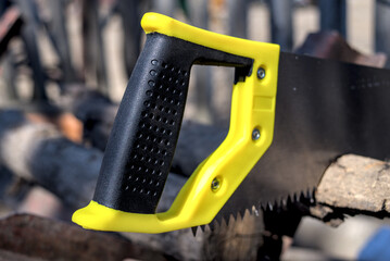 New handsaw with a plastic yellow black handle