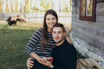 handsome man and woman hugging in the autumn garden