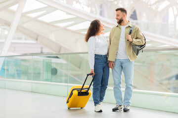 Couple With Suitcase Standing at Airport Terminal