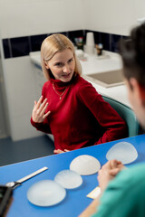 in a plastic surgery clinic a young girl is consulted for breast augmentation