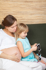 Little girl amazed by ultrasound images of her unborn sibling