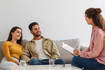 Happy couple listening to therapist during family session