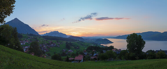 view from lookout point above tourist resort Krattigen, lake Thunersee at dawn